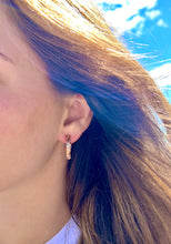 Load image into Gallery viewer, Model wearing 4mm Old English Medium Hoop Earrings with Post in 14K Pink Gold
